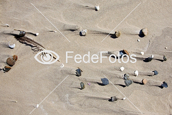 Sten på strand efter sandfygning